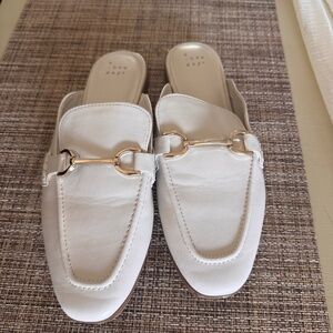 White slip on mules with gold hardware